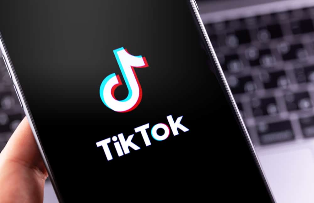 TikTok logo app on the smartphone background close up